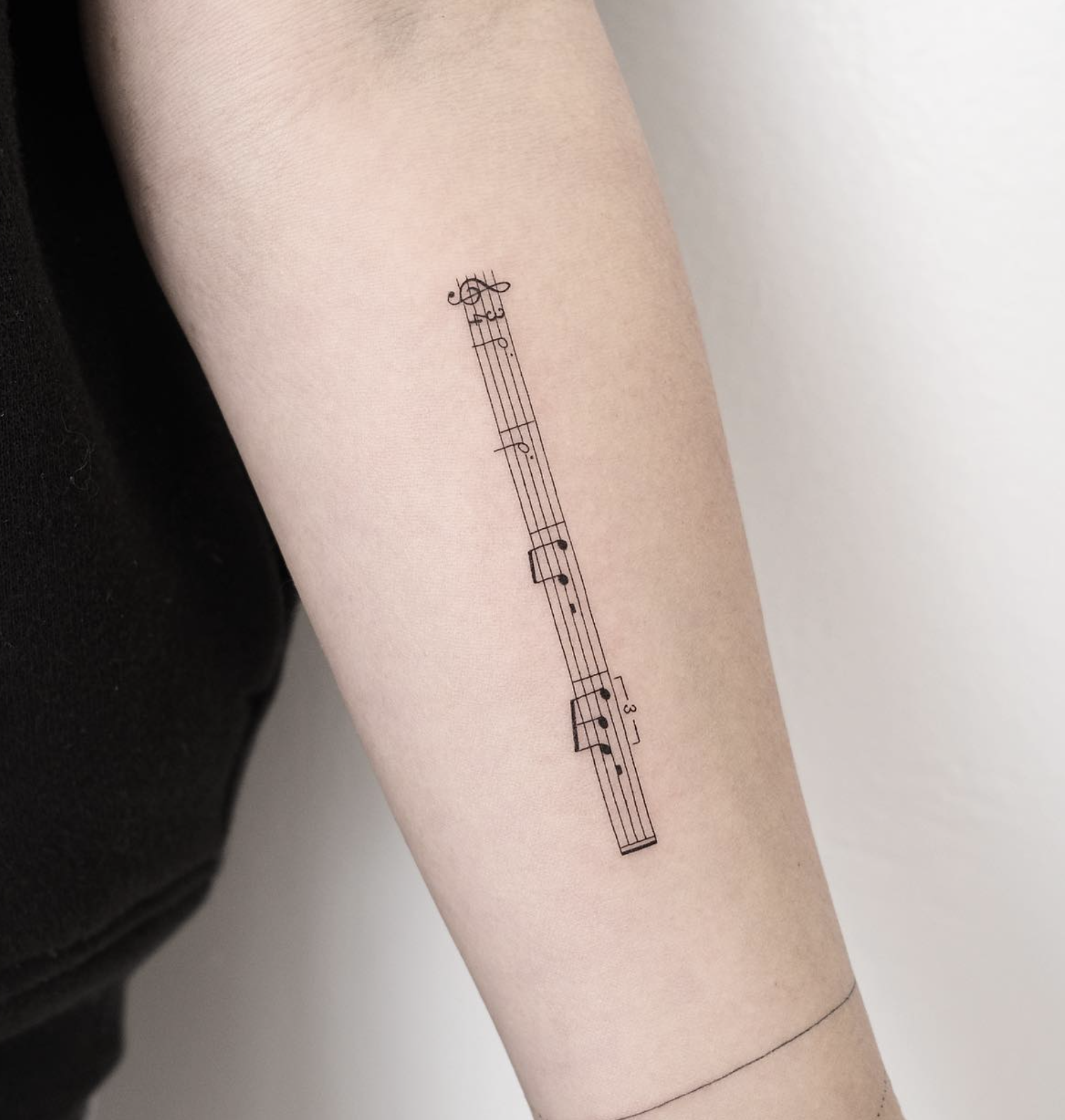 musical staff minimalist style tattoo by Niko